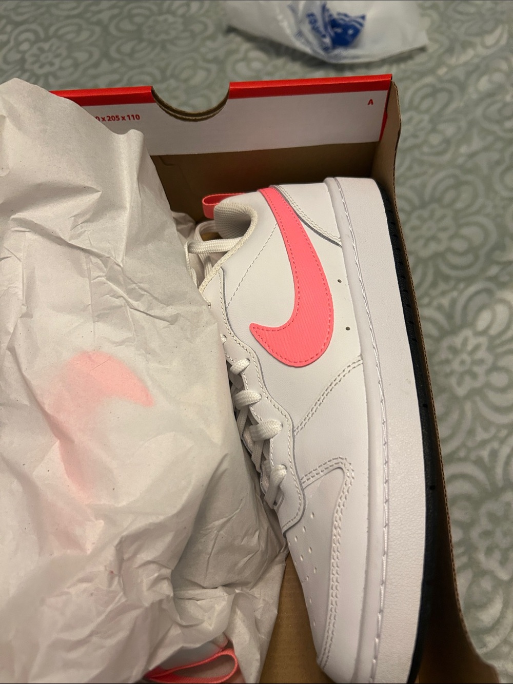Nike Women’s White Low-Top Sneakers with Pink Swoosh